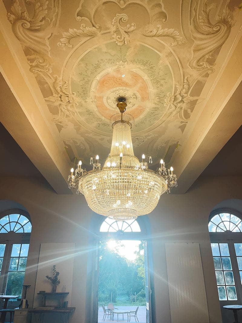 Baroque chandelier and ornate ceiling inside Schloss Dornburg