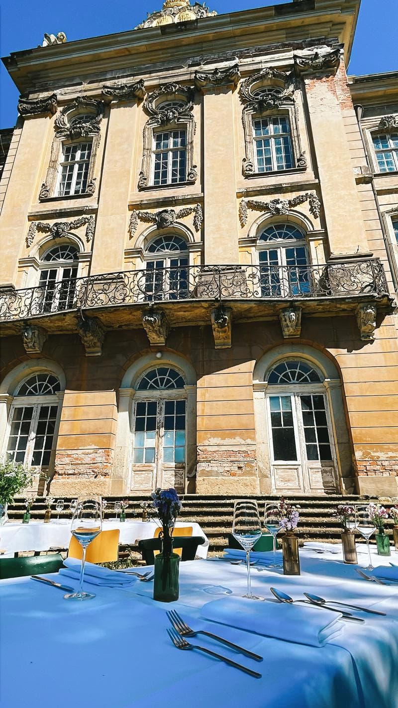 Dinner table with castle facade in the background