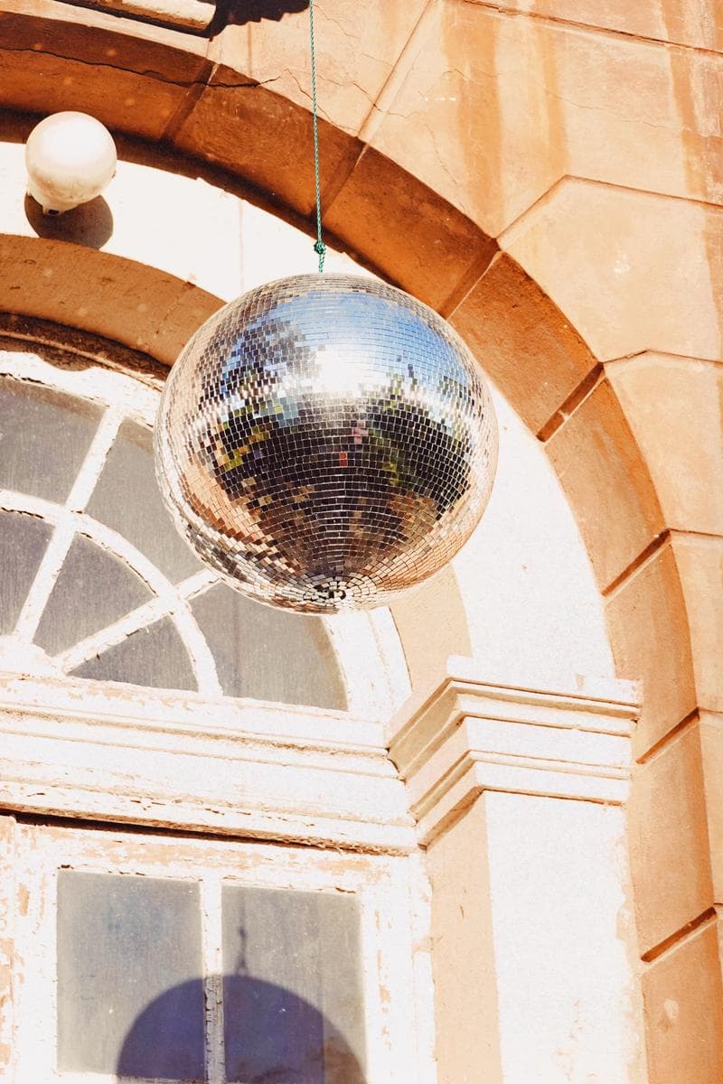 Disco ball hanging in front of baroque archway